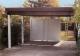 Flachdach-Carport mit Holzblende und Beton-Rückwand